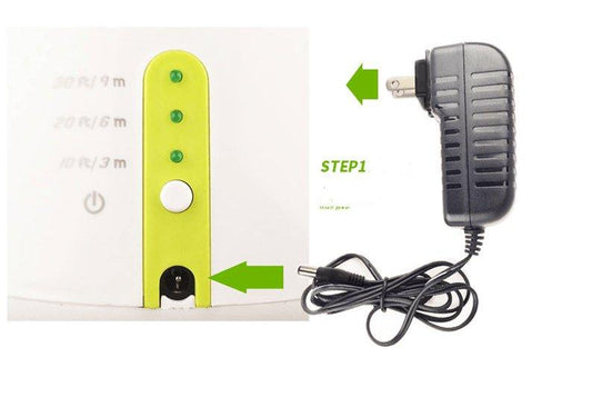 White device with green accents and a black power cord on a white background