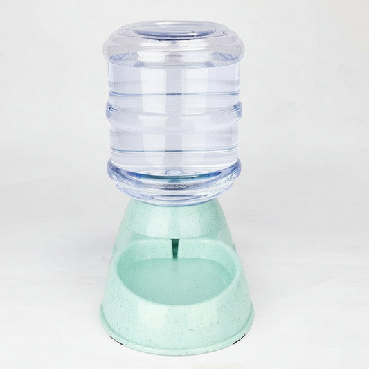 Pet water dispenser with a clear container and green base on a white background